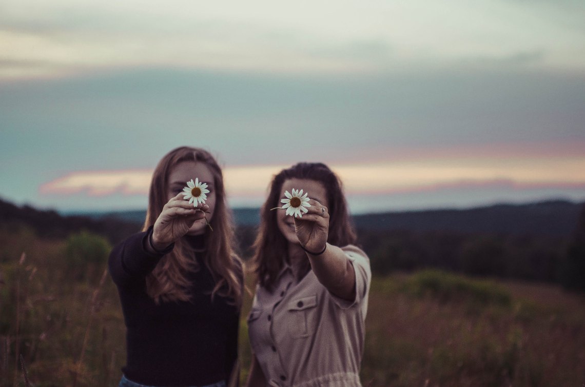 friends holding flowers