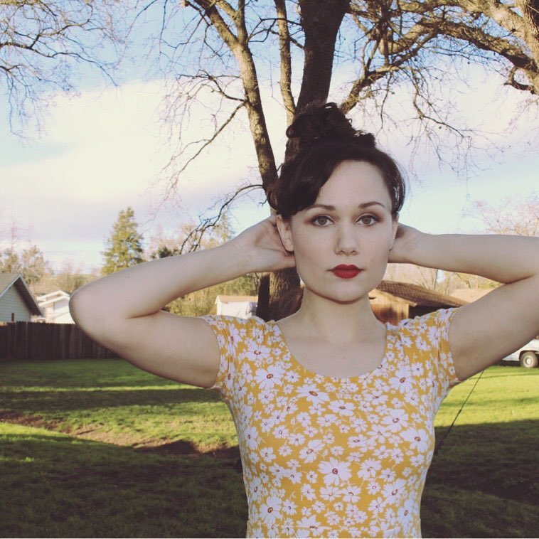 ari in a yellow dress with a great lip