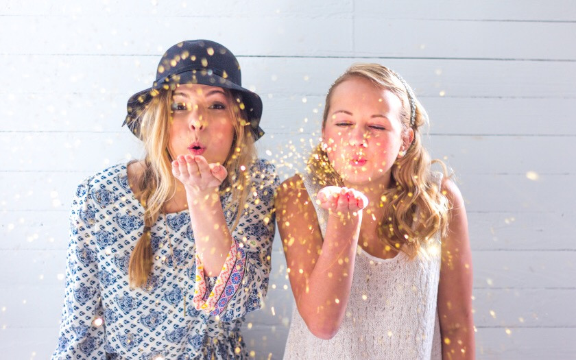 girls blowing glitter