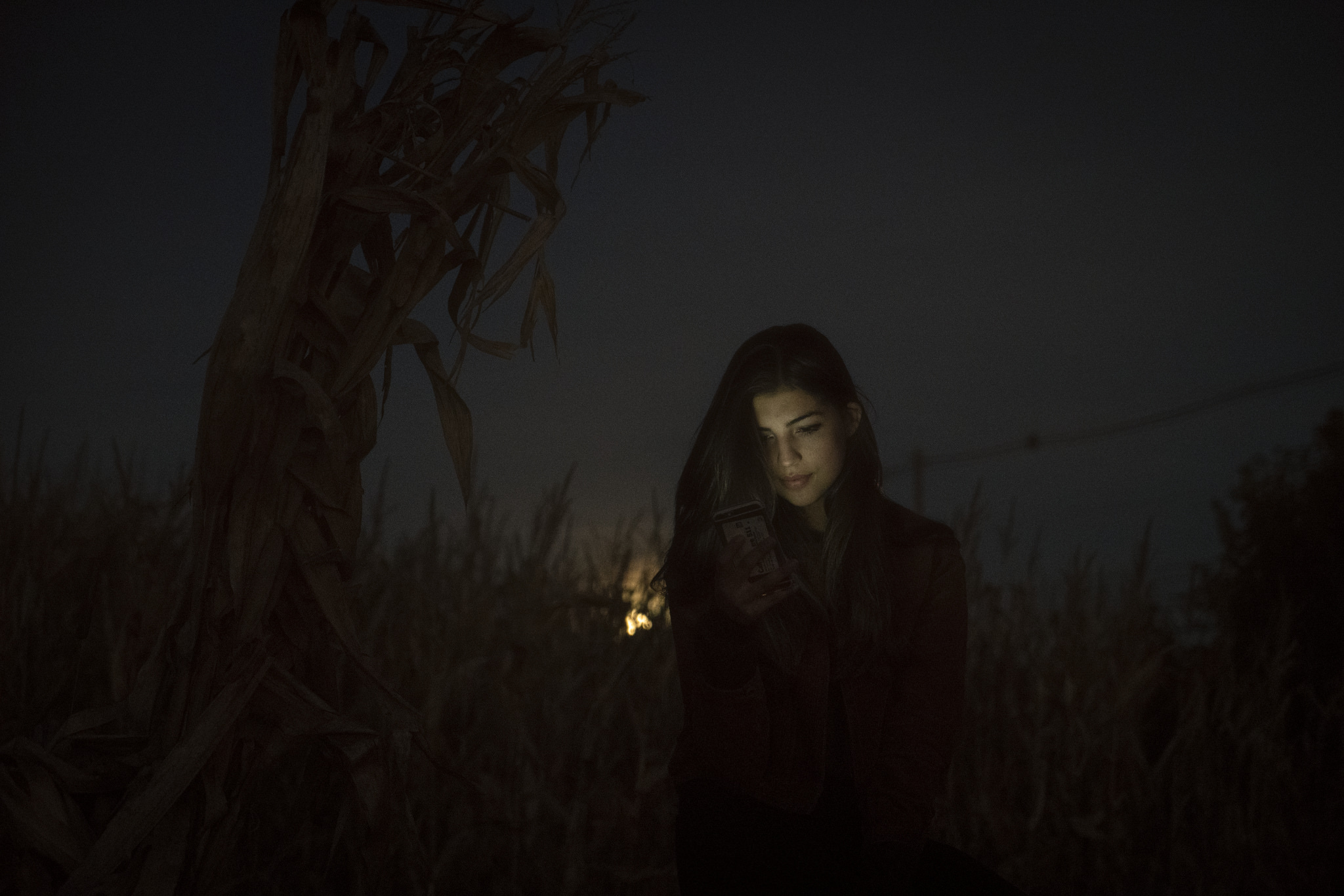 girl standing in the dark backlit by the moon
