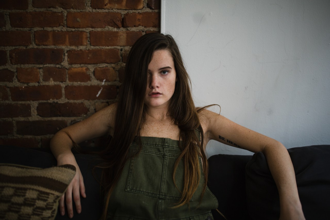 Portrait of a Girl in Green Jumpsuit in a Modern and Hip Apartment