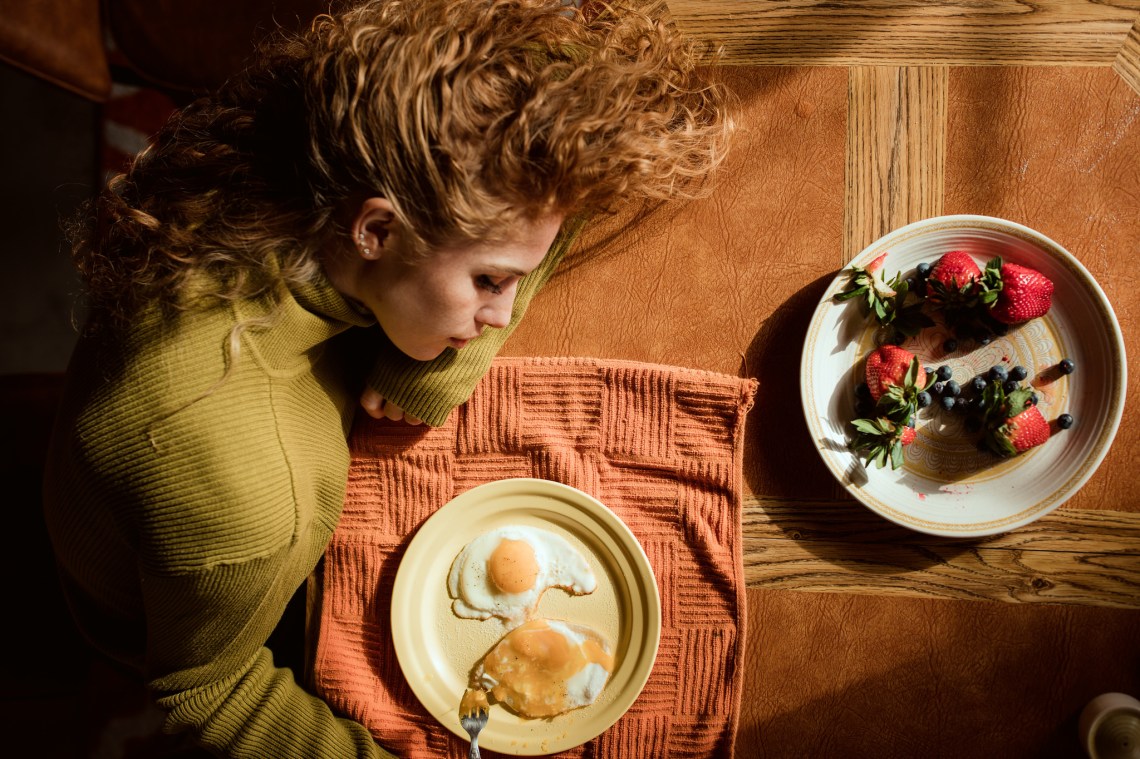 Unhappy lonely girl resting on table