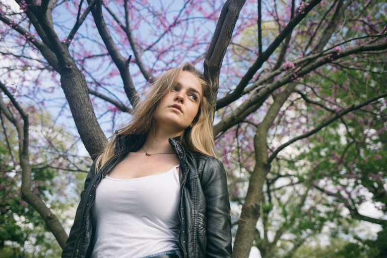 woman standing under cherry tree