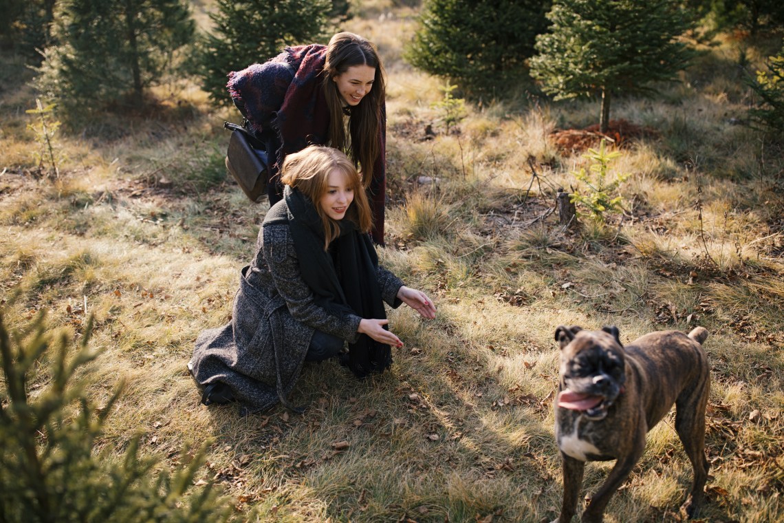 two women playing with dog