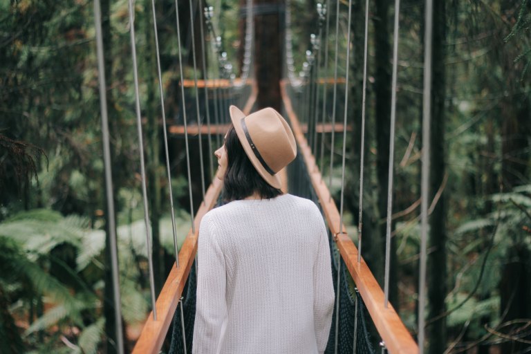 girl wandering down a bridge