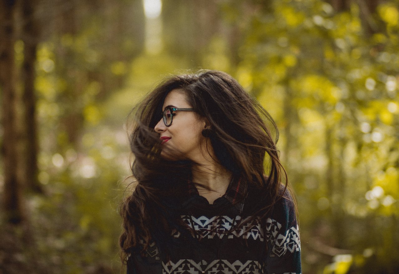 woman shaking her hair in the forest