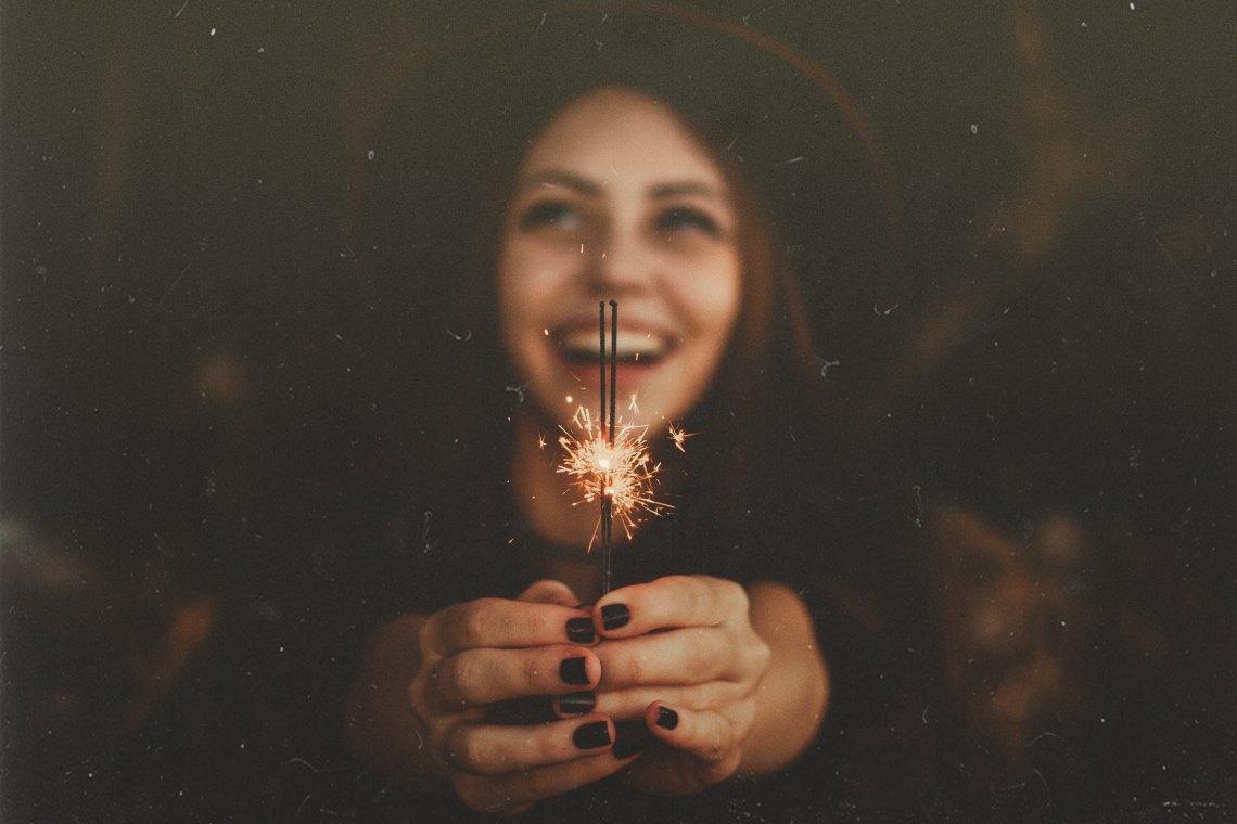 Woman holding up sparkler