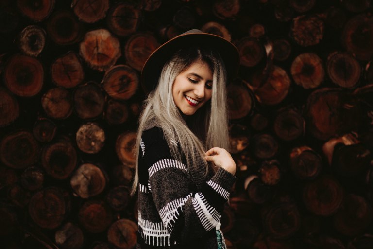 woman laughing in front of wood