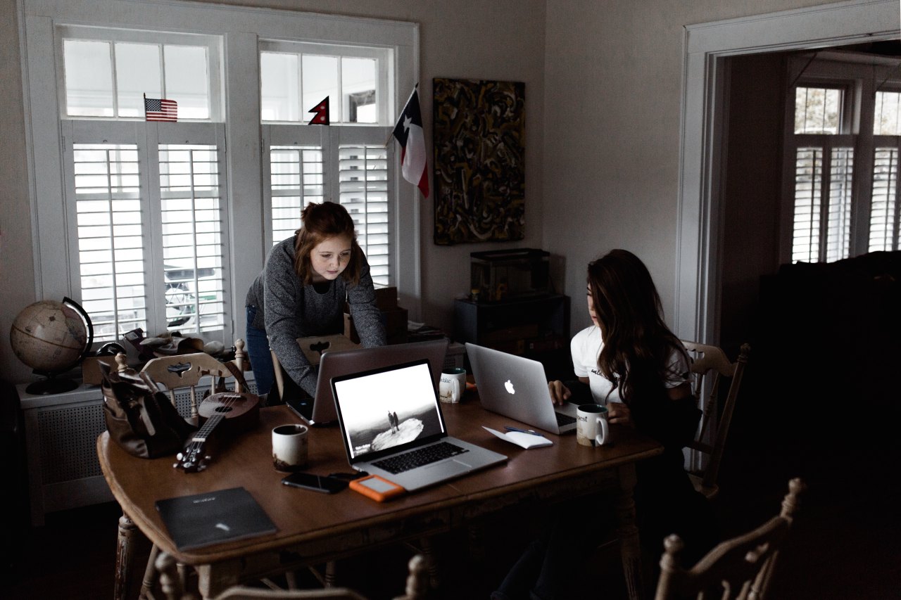 people sitting at table on laptops