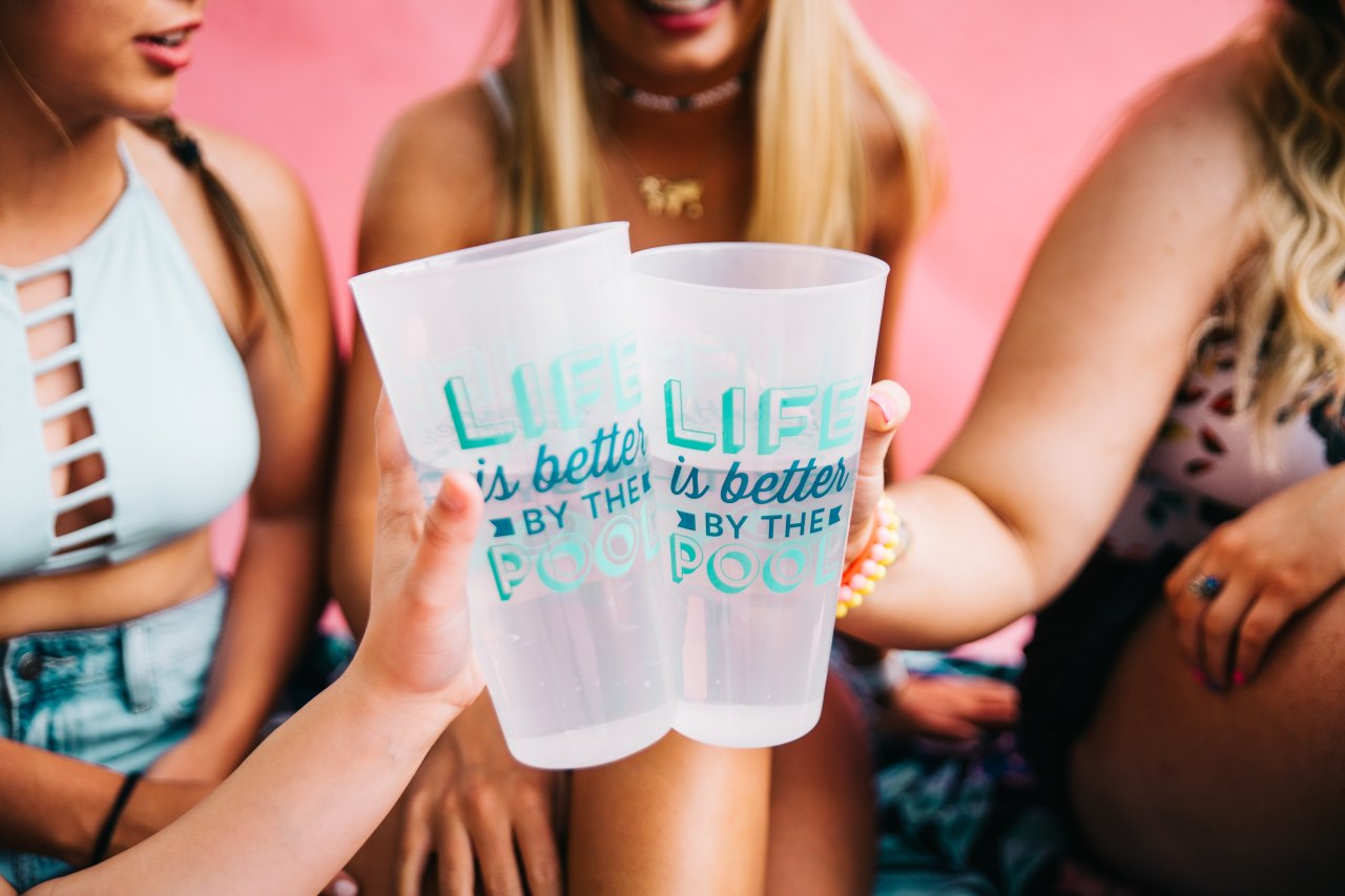 friends cheersing with plastic cups