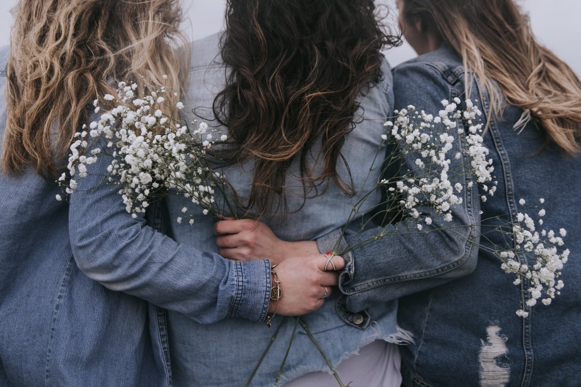 group of girls with flowers in their hands