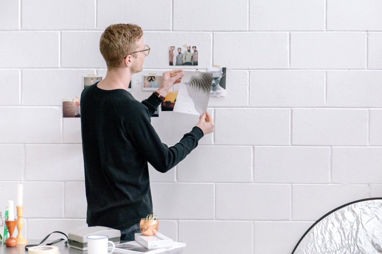 guy working on a white wall