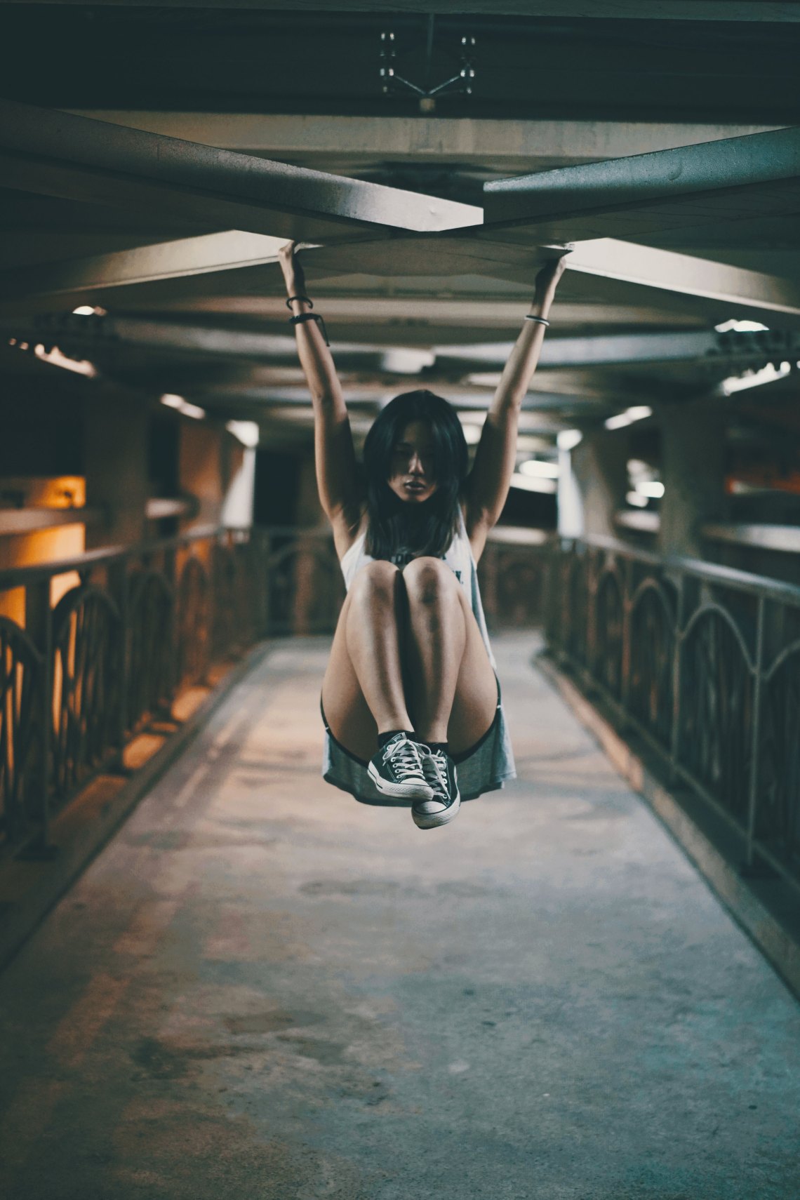 woman hanging with knees up