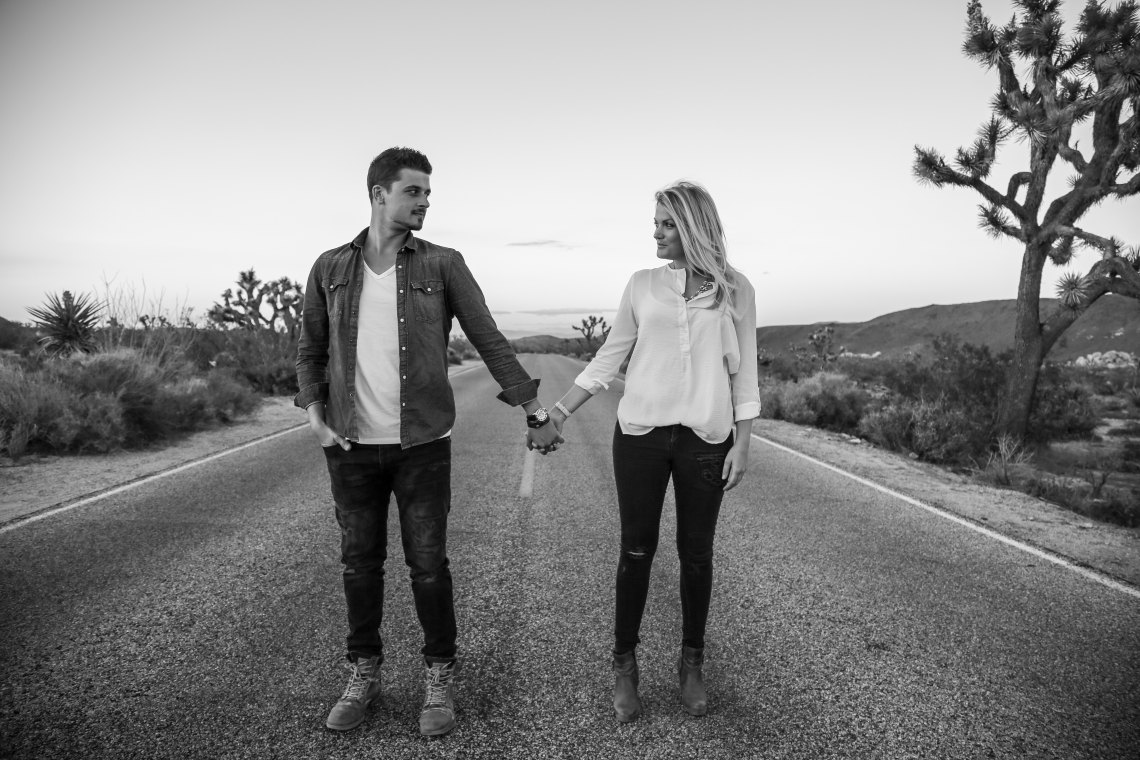 couple holding hands on street