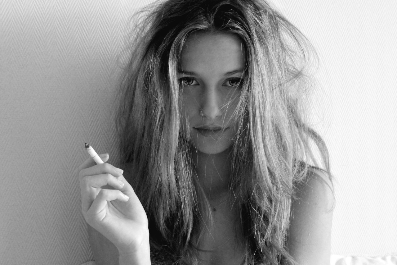 black and white photo of a woman smoking