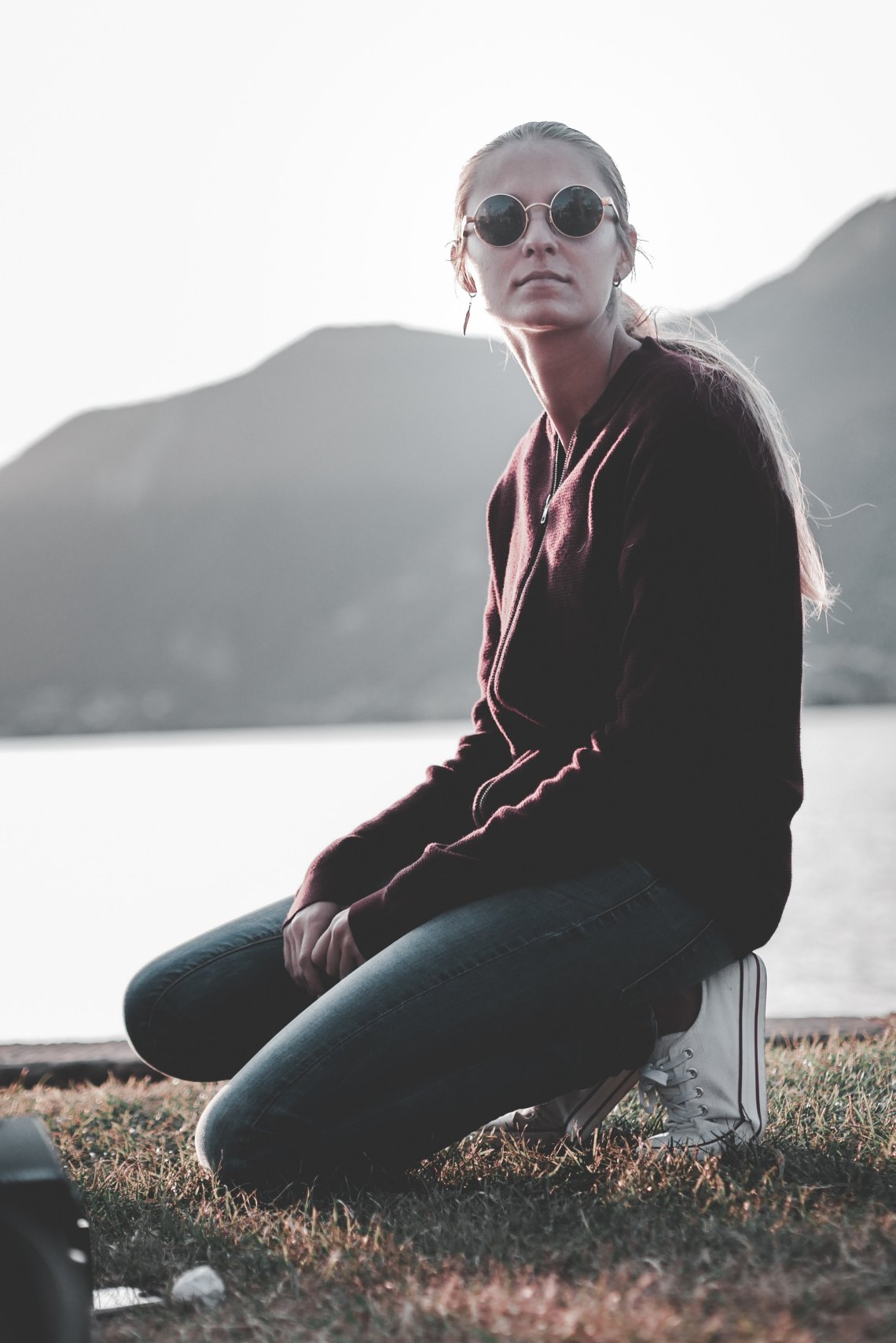 woman kneeling in front of mountains