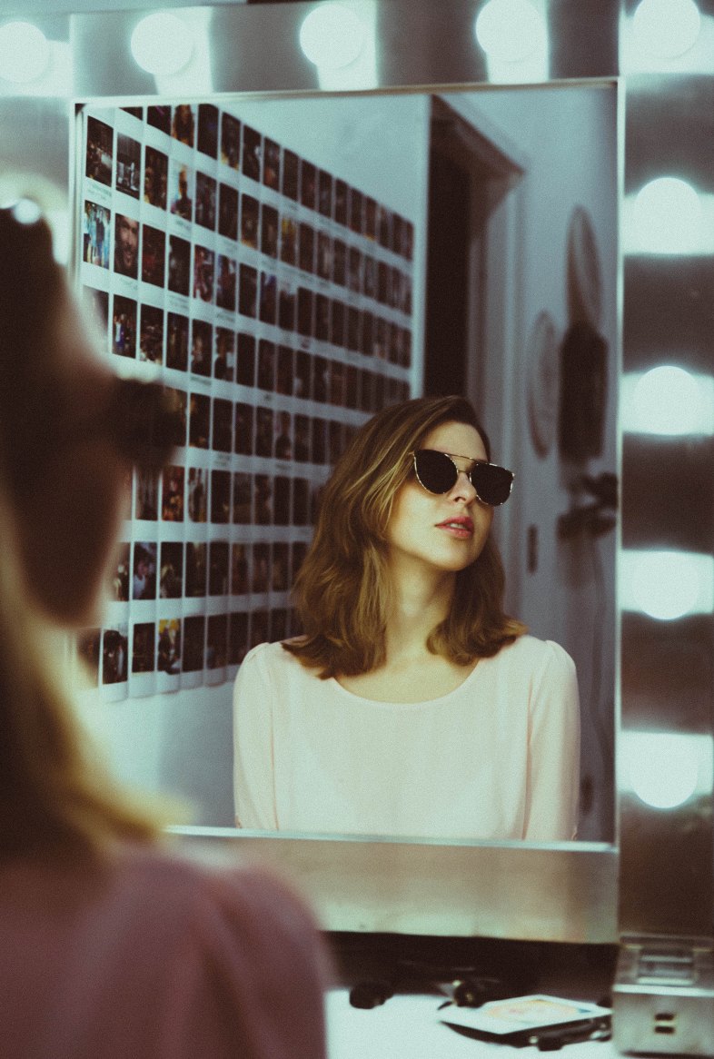 girl reflection in a mirror wearing sunglasses