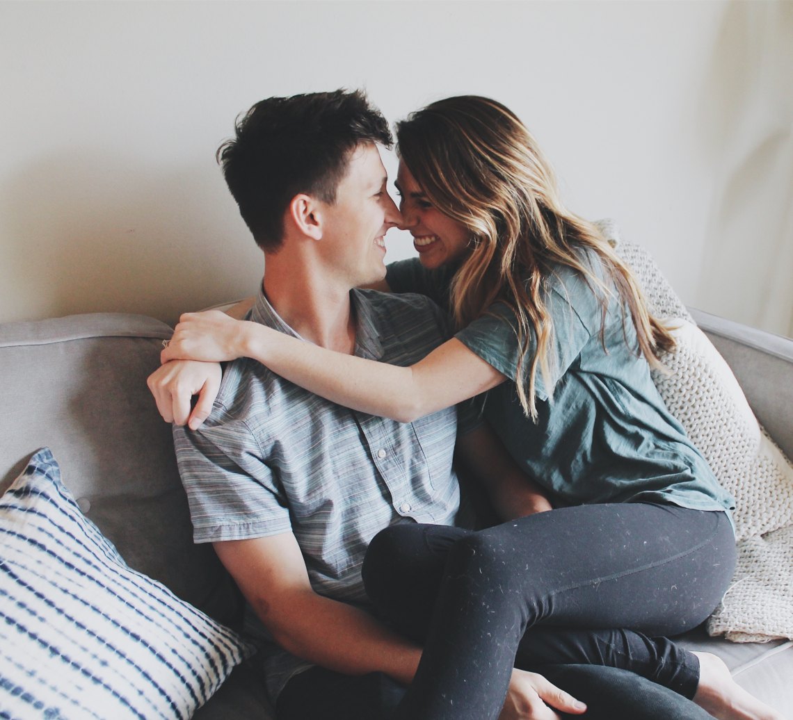 Couple hugging on couch