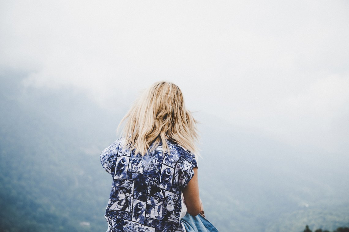 girl patterned blue shirt with her back turned