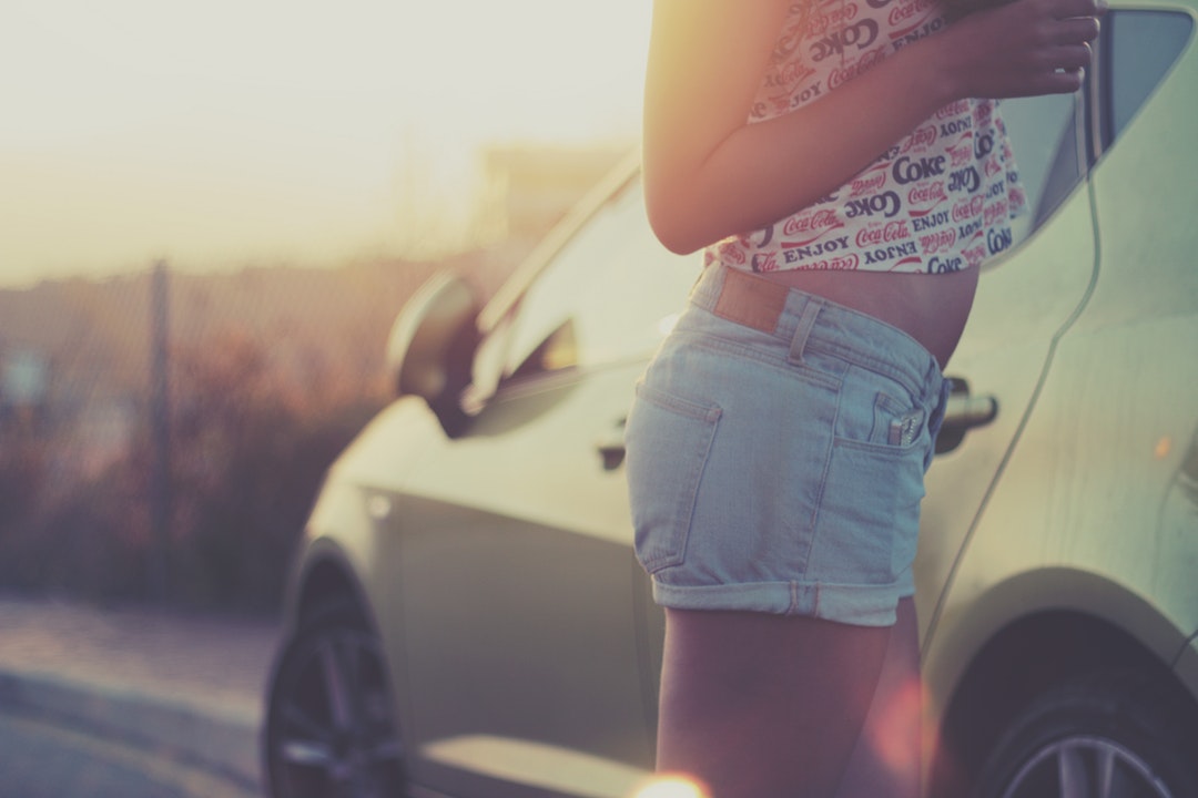 Young girl wears coca-cola t-shirt on a bright summer day