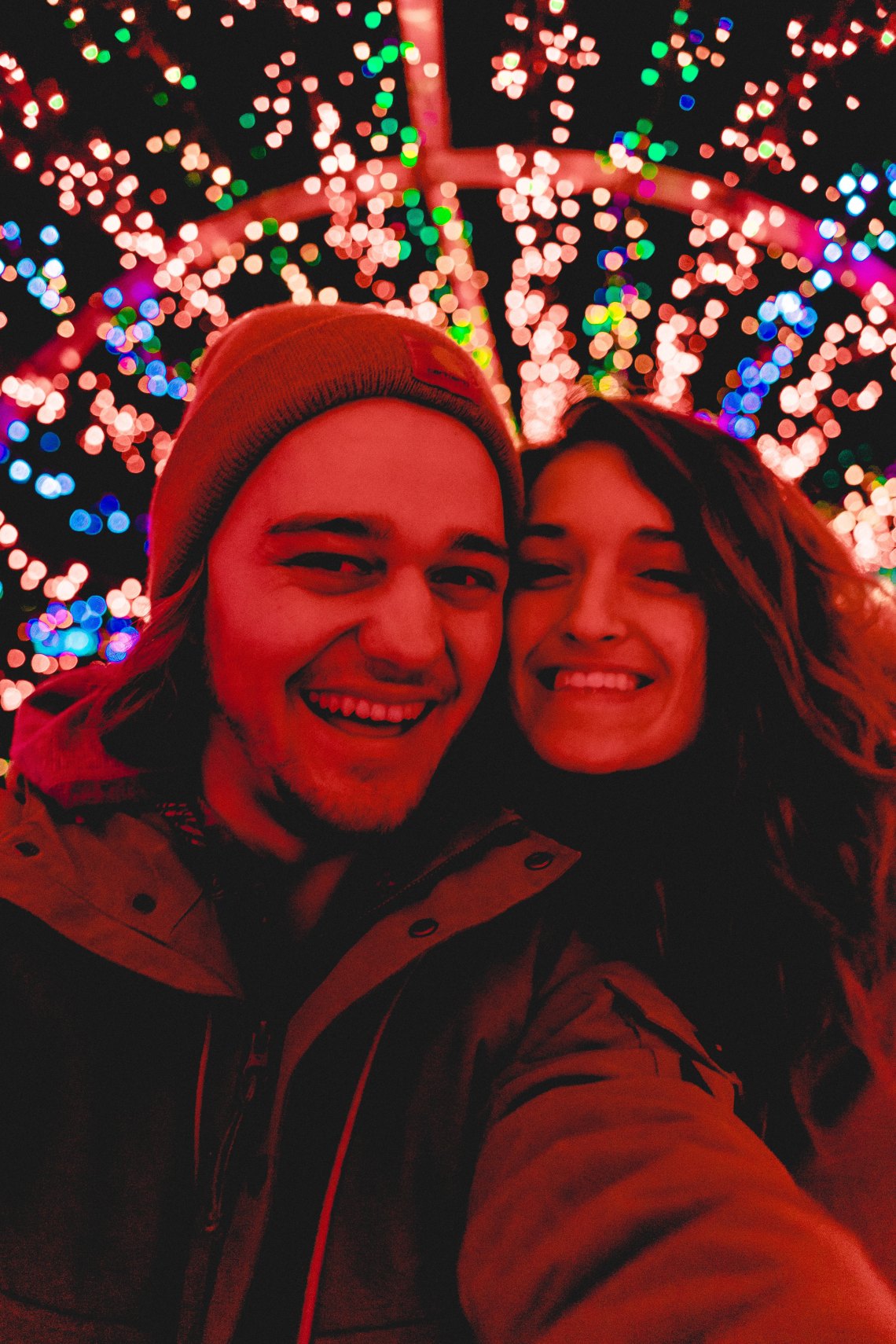 couple in front of chrismtas lights