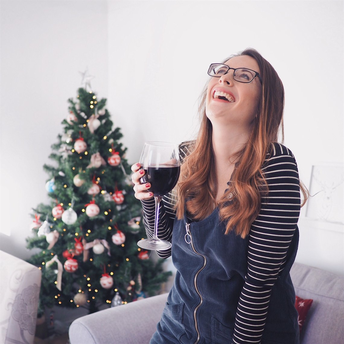 laughing with a christmas tree