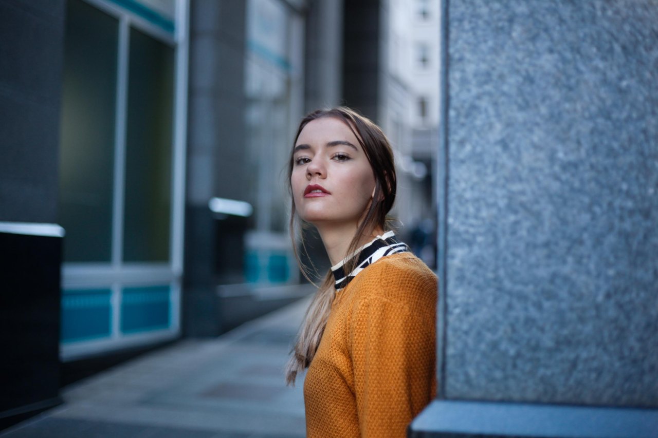 woman standing with back to wall