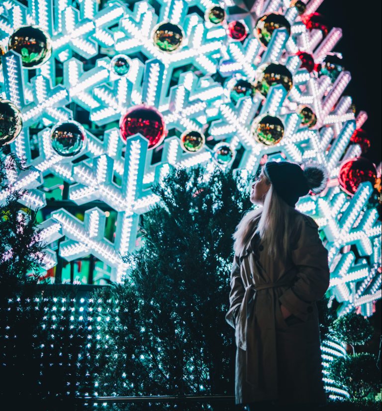 woman standing in front of christmas tree