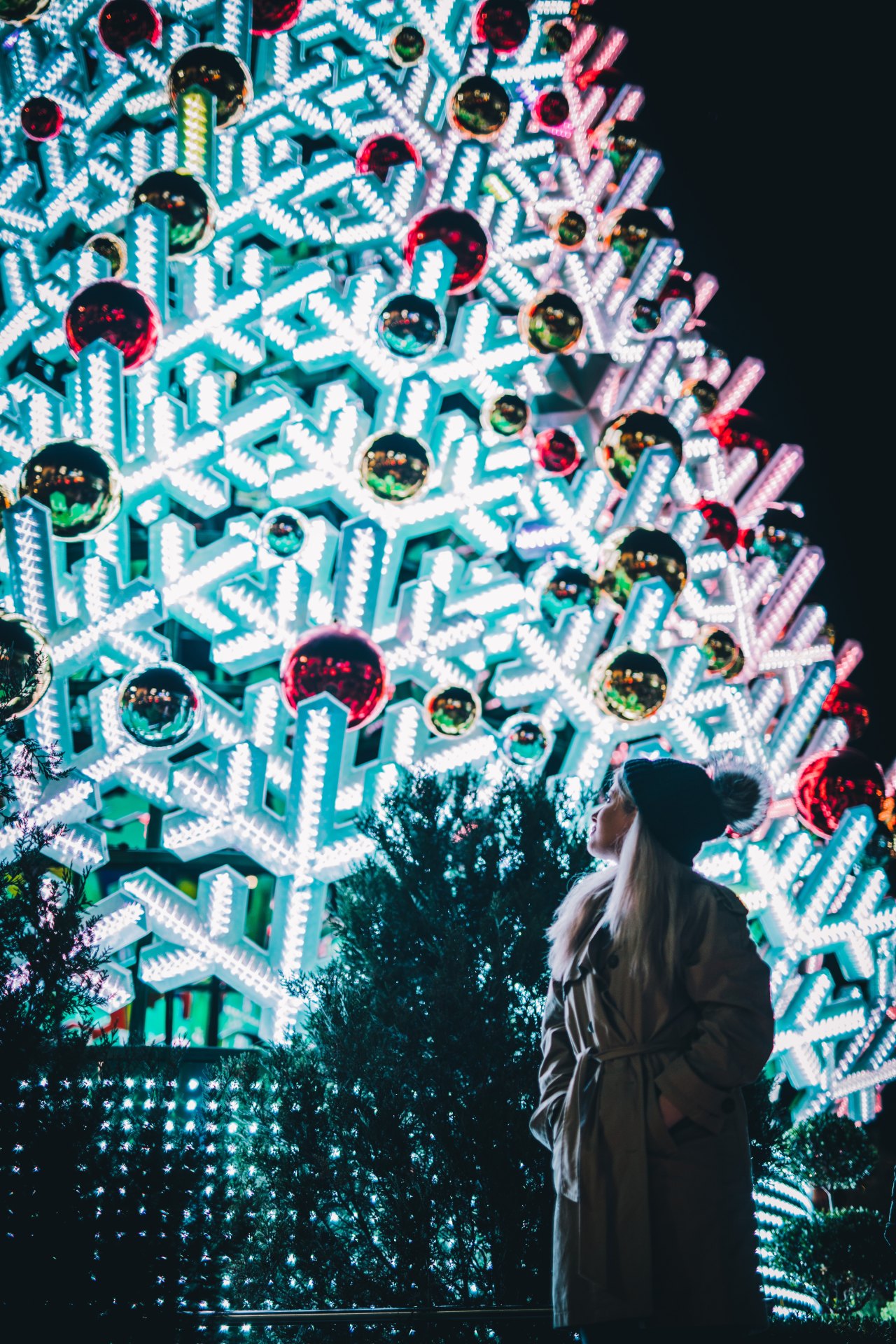 woman standing in front of christmas tree