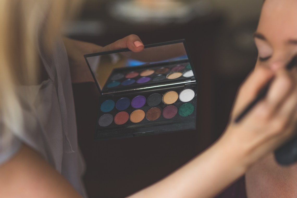 makeup artist working on a face