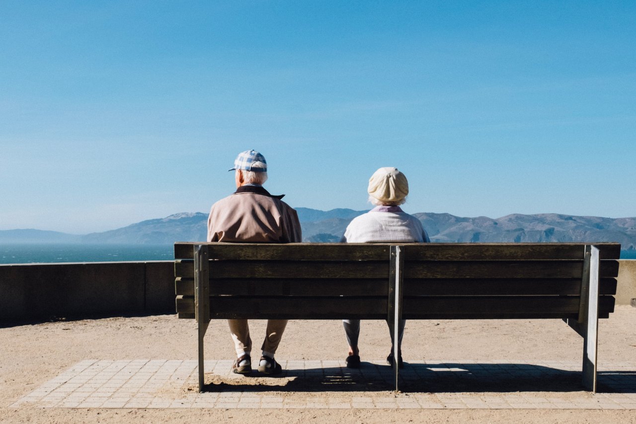 old couple sitting on bench