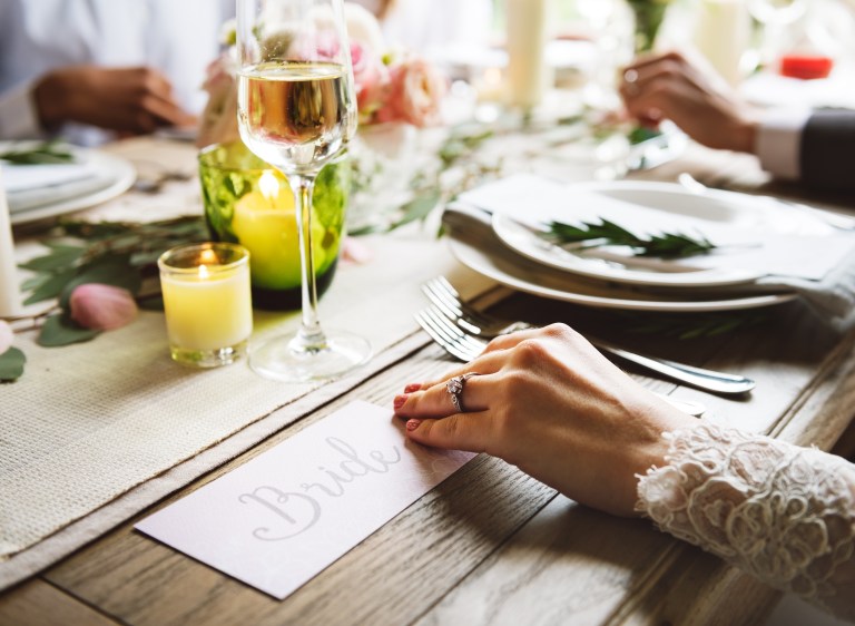 bride wearing diamond engagement ring