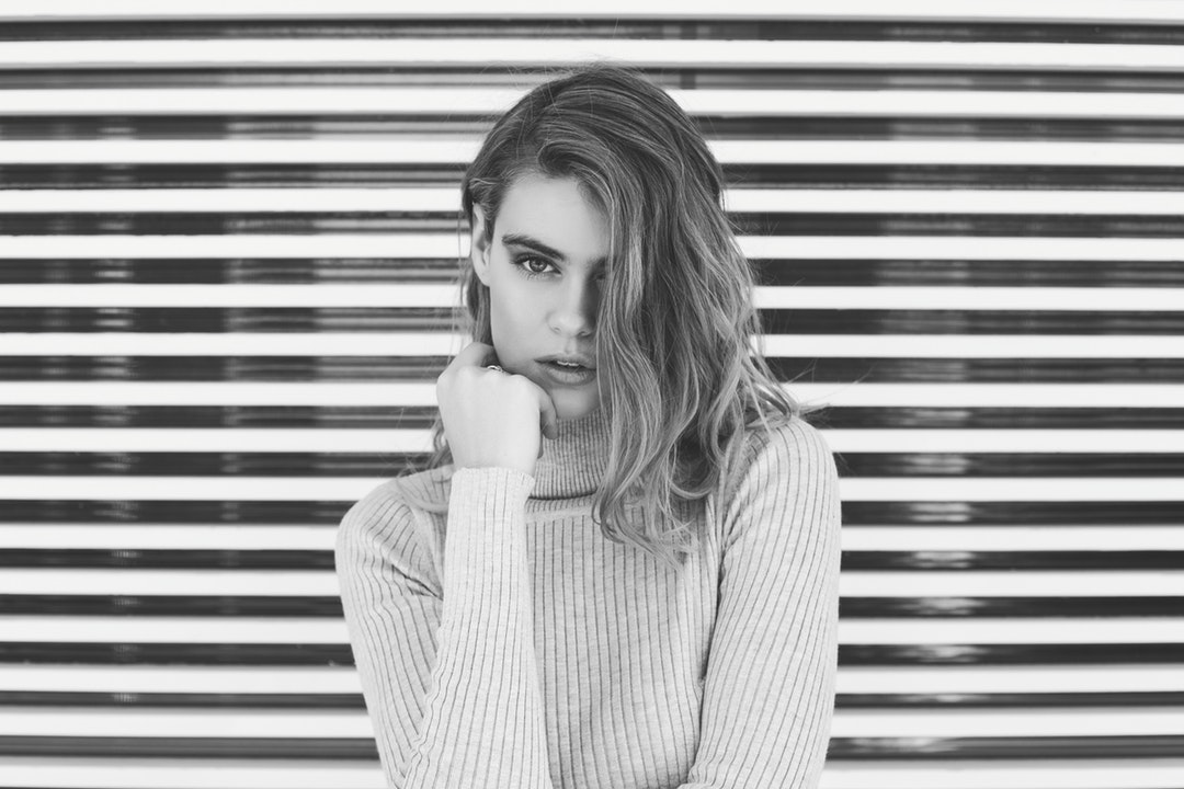 Black and white shot of attractive woman wearing turtleneck jumper in Tamarama