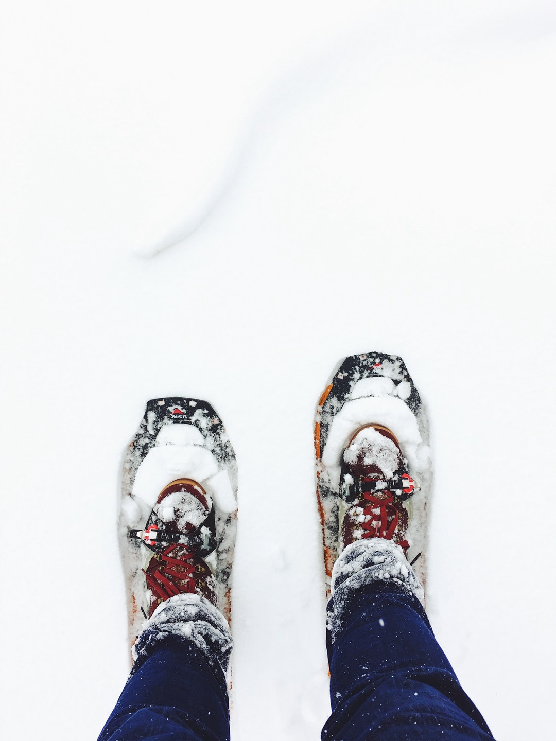 Staring down at a pair of winter shoes in the snow in Kamas, Utah