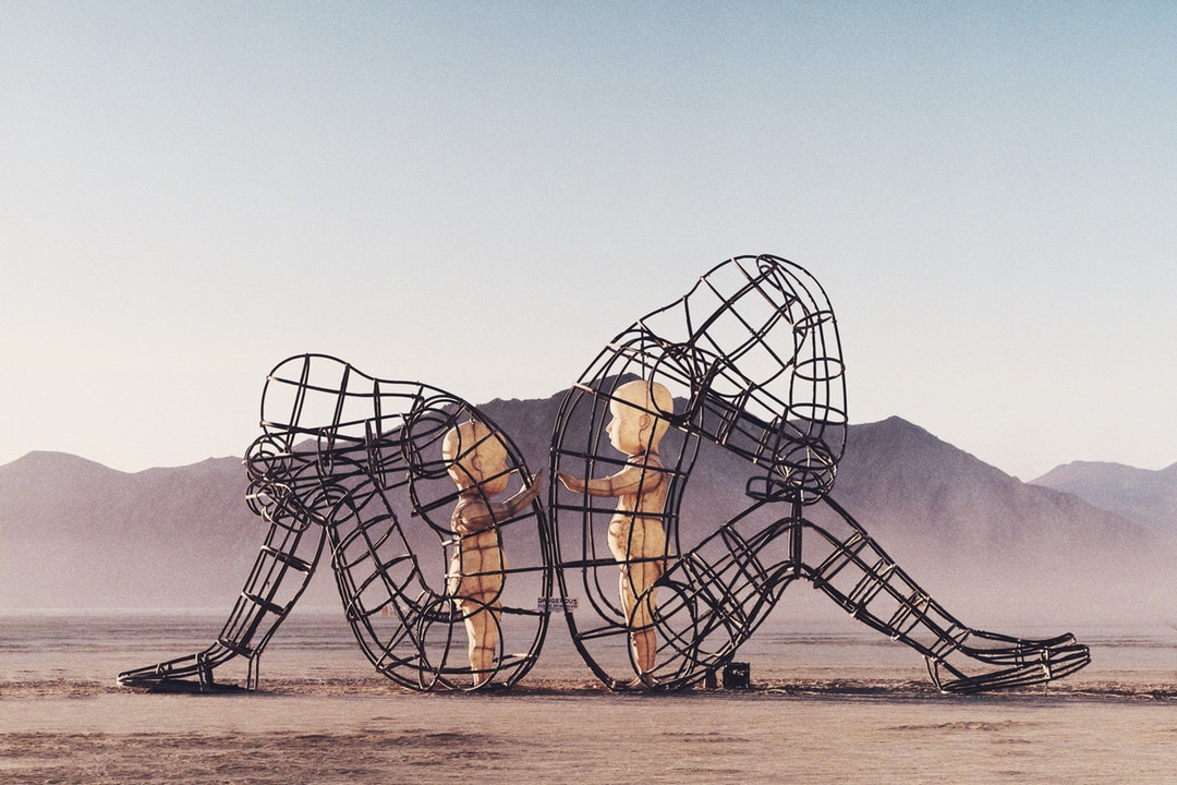 Burning Man wire sculpture with baby dolls in Black Rock Desert