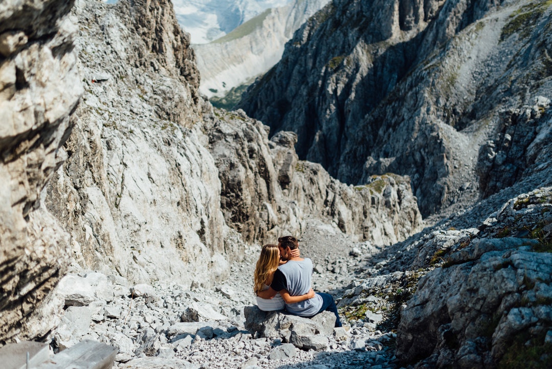 Couple embraces in a rocky mountain landscape