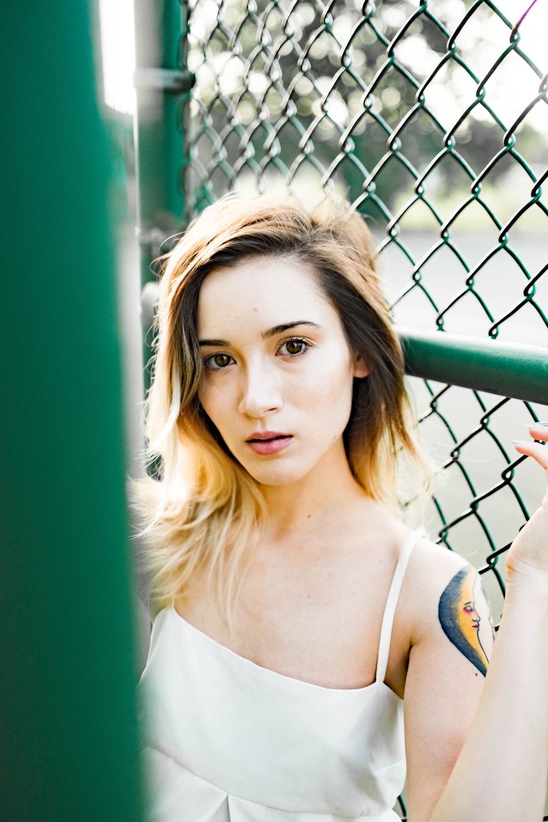 woman standing near a fence