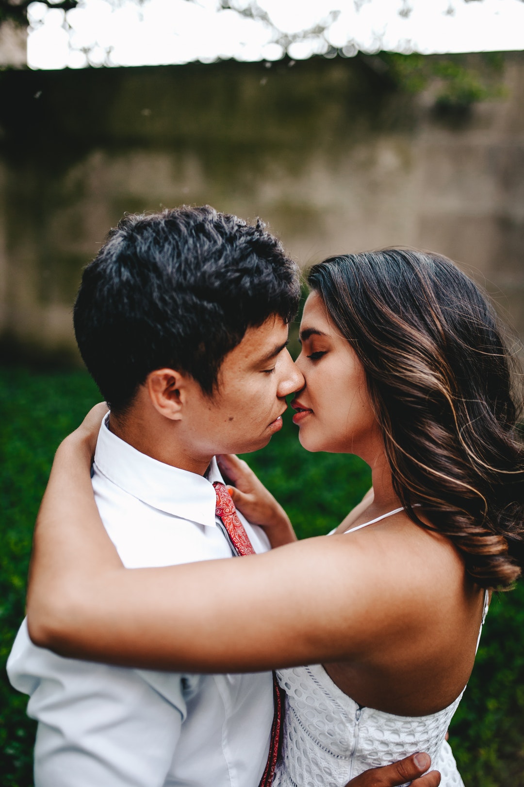 A man and woman embracing for a kiss.