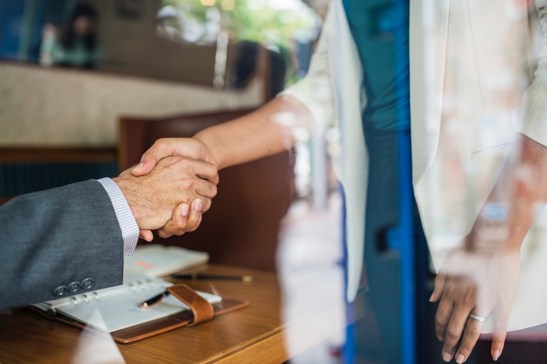 woman and man handshaking