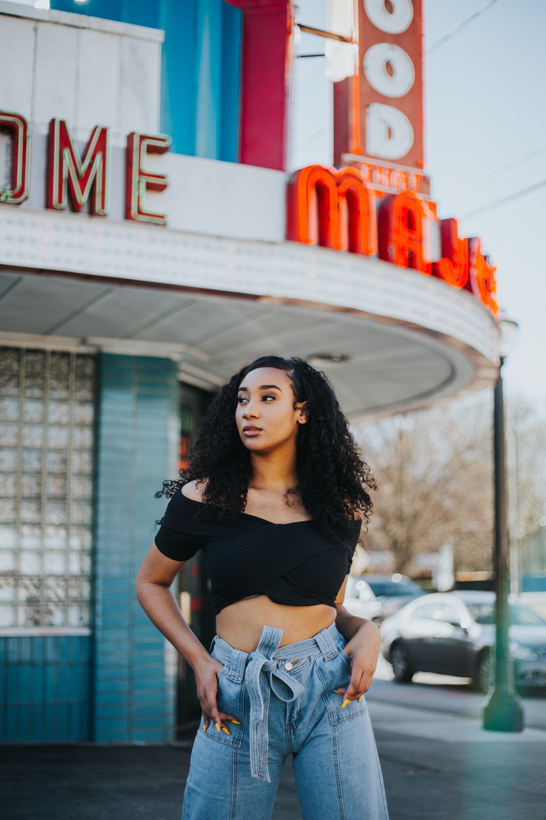 selective focus photo of woman standing near building