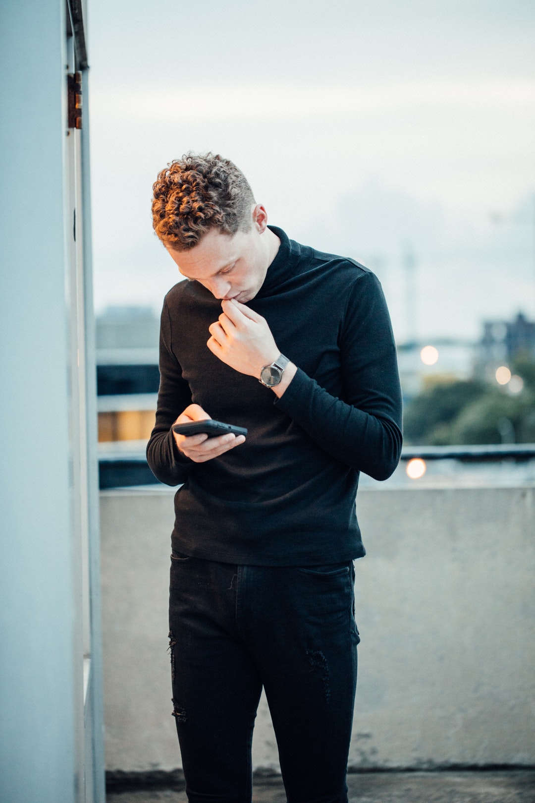 man stand holding smartphone