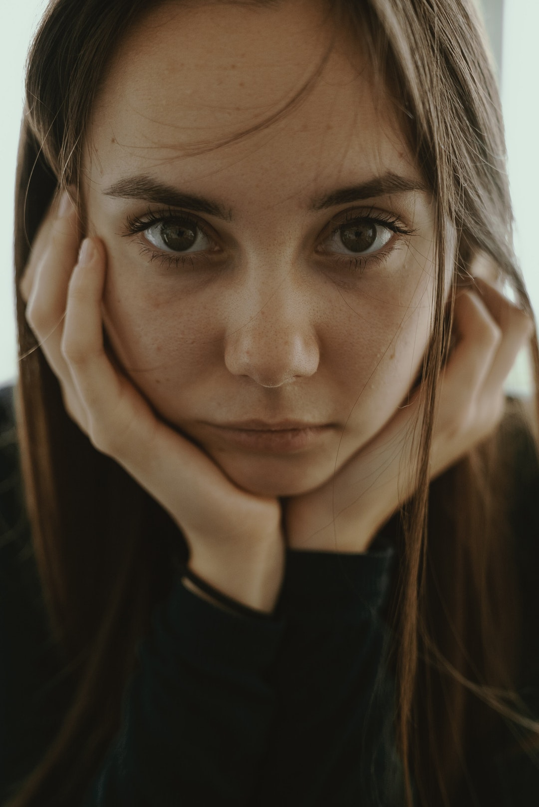 woman doing chin gesture while taking photo