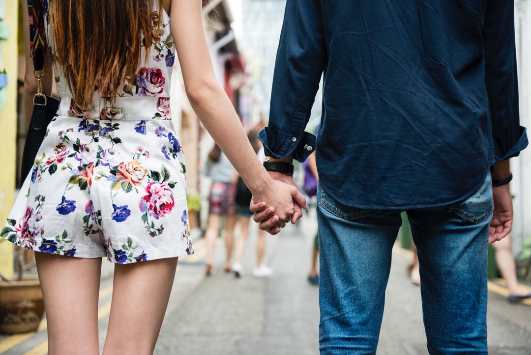 man and woman holding hands