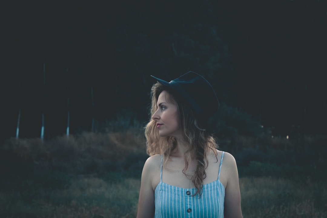 woman wearing cap standing on field