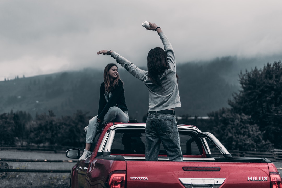 two girl on red truck