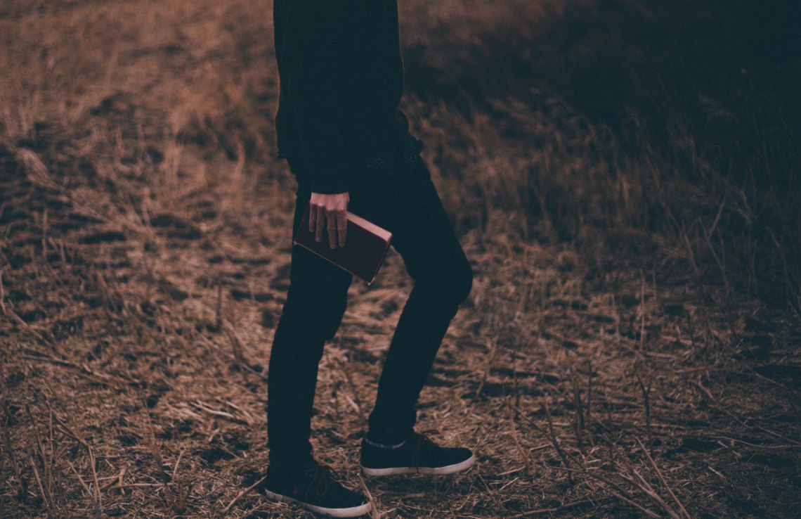 man walking with book