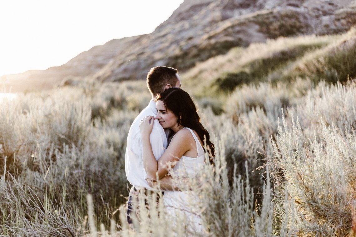 couple embracing in a field