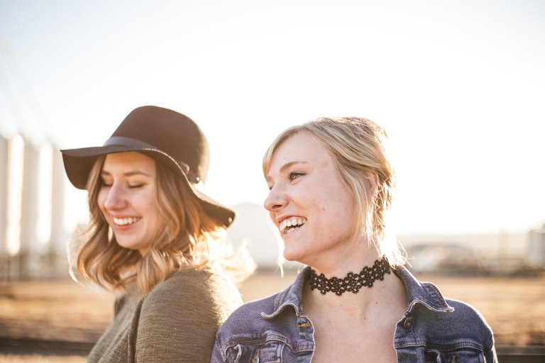 two friends laughing in the sun