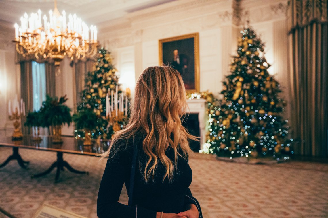 girl wandering around next to a tree