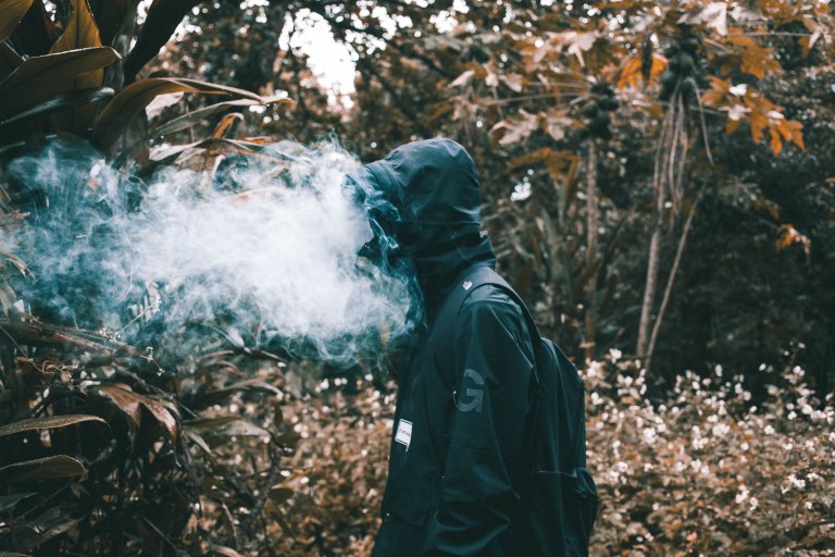 man with smoke all up in his face